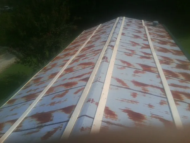 Rusted metal roof panels with new wood purlins before replacement — Storm Damage Roof Repair in Galway by Roofing Brothers